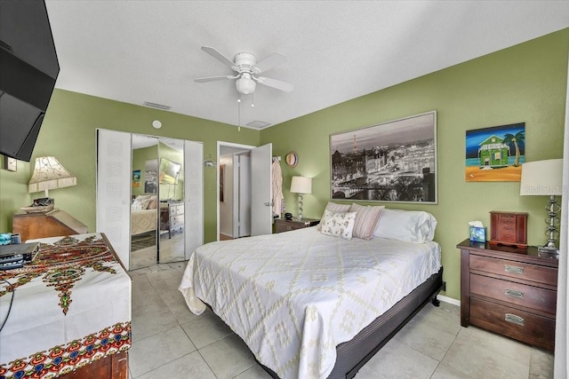 bedroom featuring visible vents, tile patterned floors, baseboards, and ceiling fan