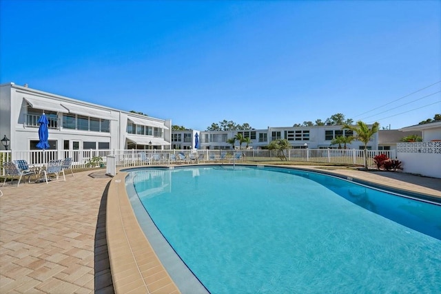 community pool featuring fence and a patio