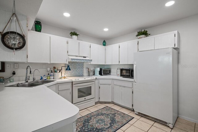 1655 S Highland Ave Unit C155, Largo, FL 33756 - kitchen featuring white appliances, under cabinet range hood, a sink, light tile patterned floors, and recessed lighting
