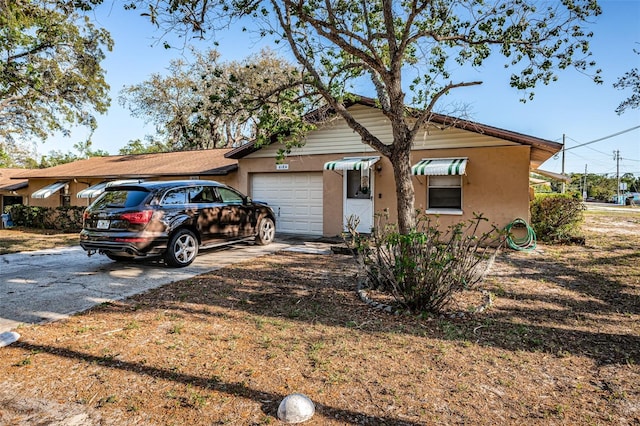 618 July Dr, Tarpon Springs, FL 34689 - single story home with a garage, concrete driveway, and stucco siding