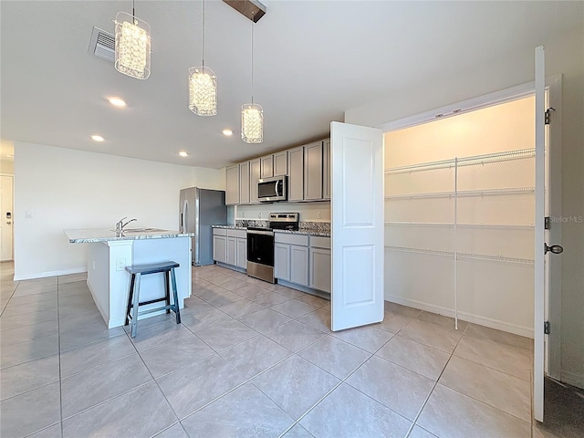 kitchen with light tile patterned floors, stainless steel appliances, gray cabinetry, visible vents, and recessed lighting