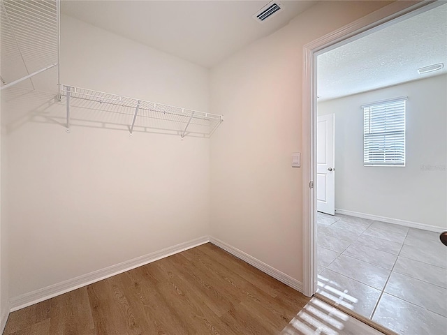spacious closet with light wood finished floors and visible vents