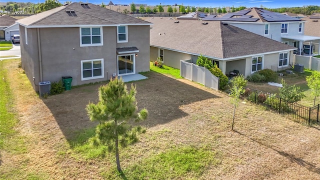 back of property with a residential view, roof with shingles, and stucco siding