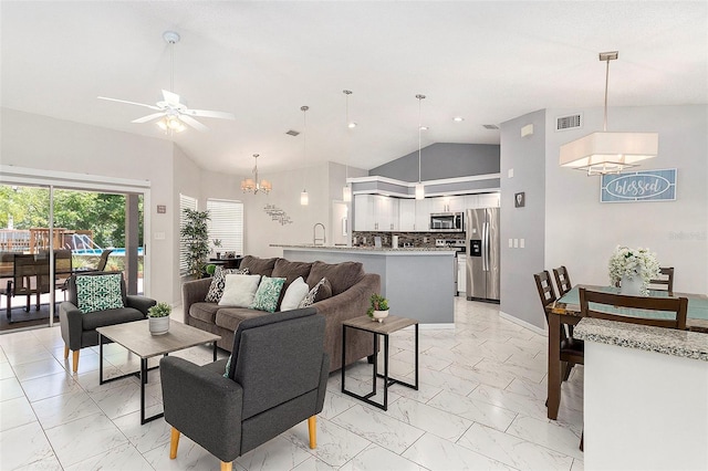 living area featuring high vaulted ceiling, marble finish floor, visible vents, and ceiling fan with notable chandelier