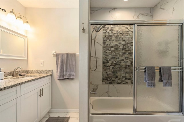 bathroom with enclosed tub / shower combo, marble finish floor, baseboards, and vanity