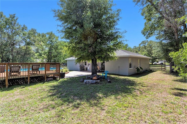 view of yard featuring fence and a deck