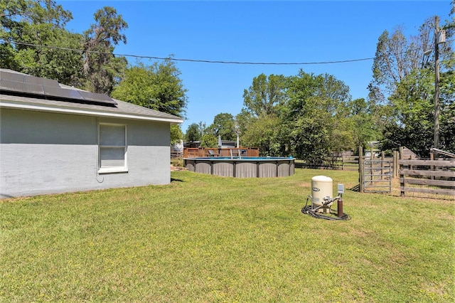 view of yard with an outdoor pool and fence