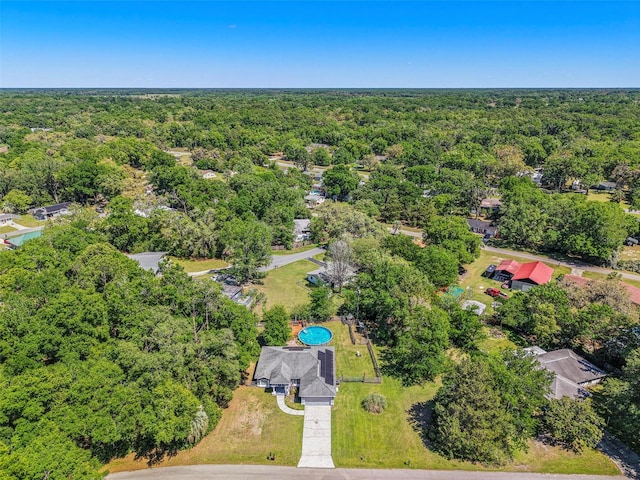 drone / aerial view with a wooded view