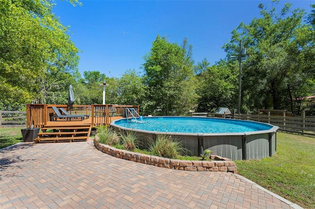 view of pool featuring a fenced in pool, fence, and a deck
