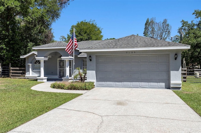single story home with fence, concrete driveway, an attached garage, stucco siding, and a front yard