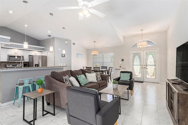 living area with recessed lighting, lofted ceiling, marble finish floor, a ceiling fan, and french doors