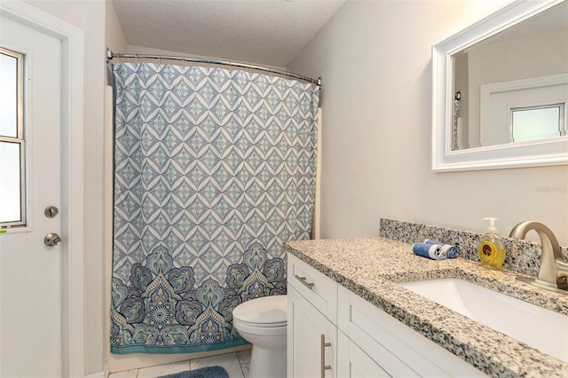 bathroom featuring tile patterned floors, a textured ceiling, vanity, a shower with curtain, and toilet