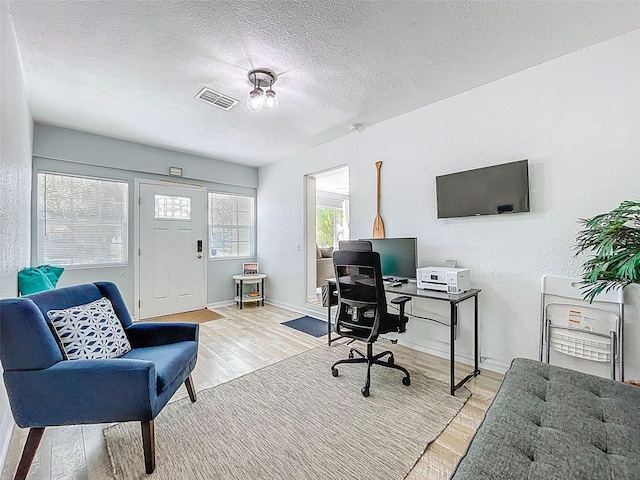 1600 Pasadena Dr, Dunedin, FL 34698 - office space with wood finished floors, a textured ceiling, and baseboards