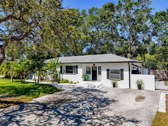 1600 Pasadena Dr, Dunedin, FL 34698 - ranch-style house with driveway and stucco siding
