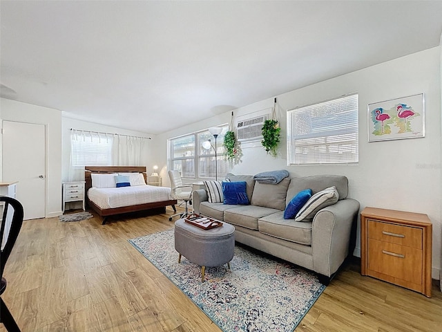 1600 Pasadena Dr, Dunedin, FL 34698 - bedroom featuring light wood-style flooring and an AC wall unit