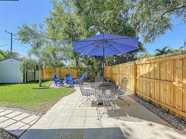 1600 Pasadena Dr, Dunedin, FL 34698 - view of patio / terrace with outdoor dining space and an outbuilding