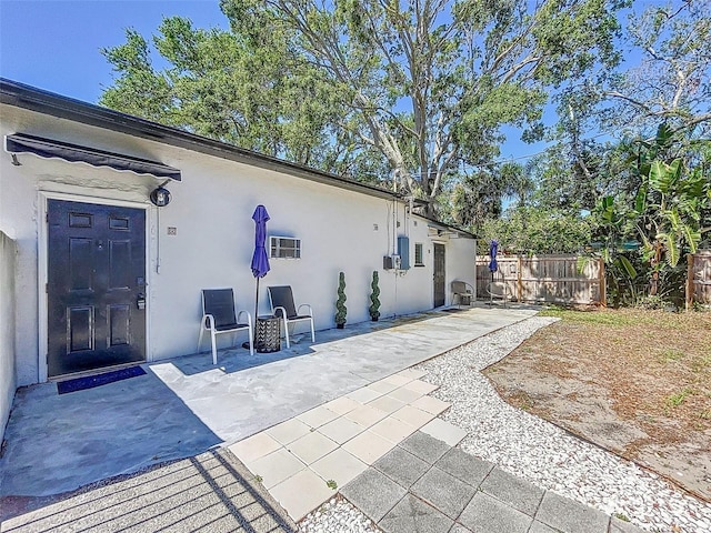 1600 Pasadena Dr, Dunedin, FL 34698 - rear view of house with stucco siding and a patio
