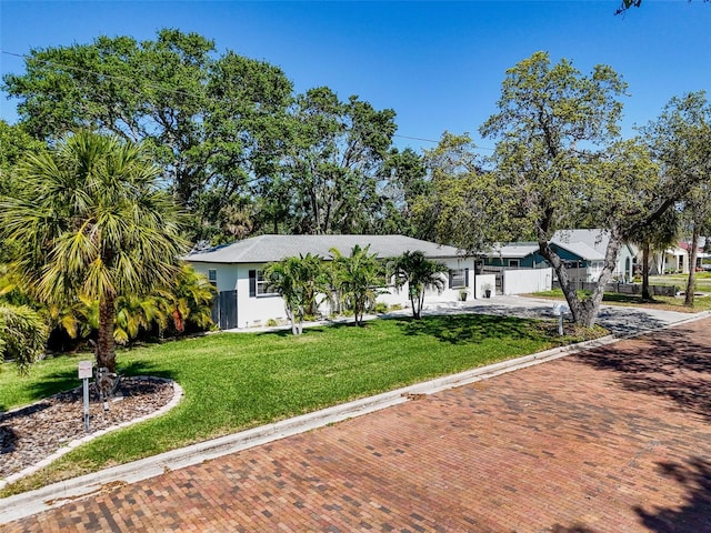 1600 Pasadena Dr, Dunedin, FL 34698 - view of front of property with decorative driveway and a front yard