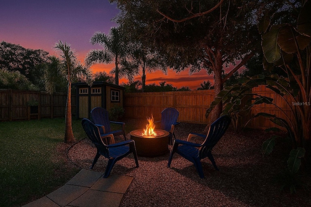 1600 Pasadena Dr, Dunedin, FL 34698 - patio terrace at dusk featuring an outdoor fire pit
