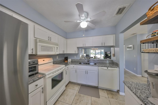 319 Kelsey Way, Sun City Center, FL 33573 - kitchen with white cabinets, a sink, visible vents, a ceiling fan, and white appliances