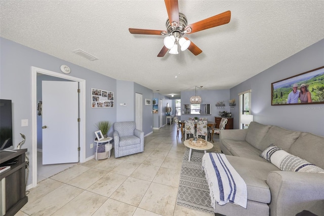 319 Kelsey Way, Sun City Center, FL 33573 - living room featuring light tile patterned floors, a textured ceiling, and ceiling fan