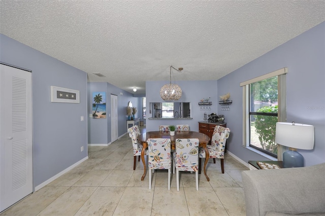 319 Kelsey Way, Sun City Center, FL 33573 - dining area with baseboards, a textured ceiling, and a notable chandelier