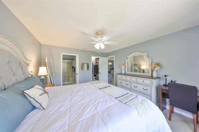 319 Kelsey Way, Sun City Center, FL 33573 - bedroom featuring tile patterned floors, a ceiling fan, a closet, ensuite bath, and a walk in closet