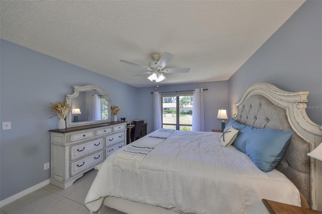 319 Kelsey Way, Sun City Center, FL 33573 - bedroom featuring a ceiling fan, baseboards, light tile patterned flooring, and a textured ceiling