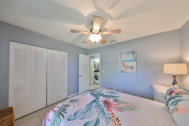 319 Kelsey Way, Sun City Center, FL 33573 - bedroom featuring visible vents, light tile patterned flooring, a closet, ceiling fan, and washer / clothes dryer