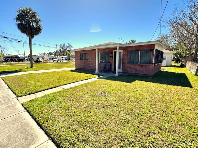 318 Banana St, Tarpon Springs, FL 34689 - exterior space with a yard, brick siding, and fence