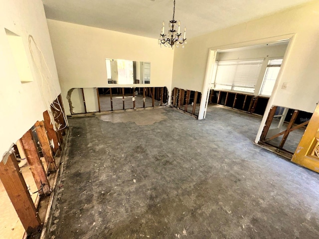 318 Banana St, Tarpon Springs, FL 34689 - unfurnished dining area with concrete flooring and a notable chandelier