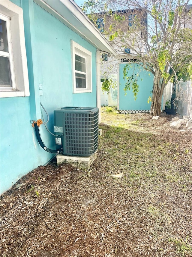 details with stucco siding and central AC unit