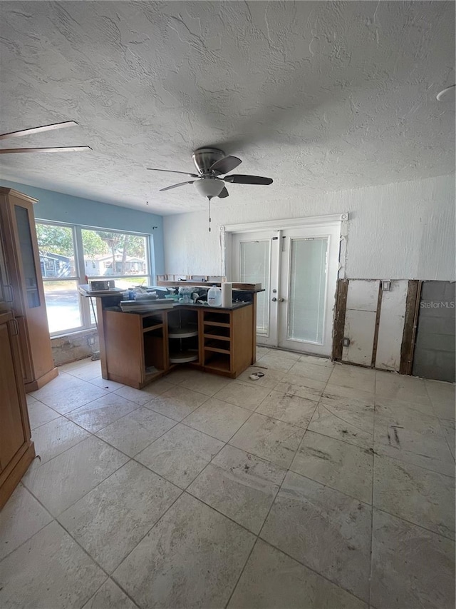 office space with ceiling fan and a textured ceiling