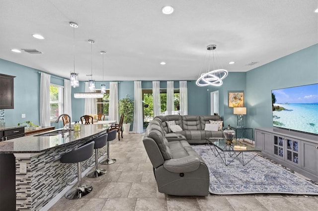 10514 Scenic Hollow Dr, Riverview, FL 33578 - living room featuring a chandelier and recessed lighting