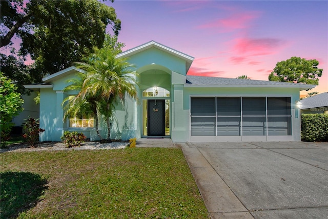 10321 Ravines Dr, New Port Richey, FL 34654 - ranch-style home featuring a front lawn, an attached garage, and stucco siding
