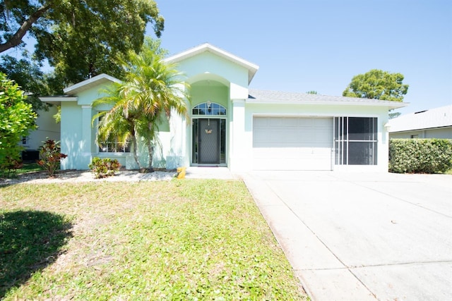 10321 Ravines Dr, New Port Richey, FL 34654 - ranch-style home featuring driveway, a garage, stucco siding, and a front yard