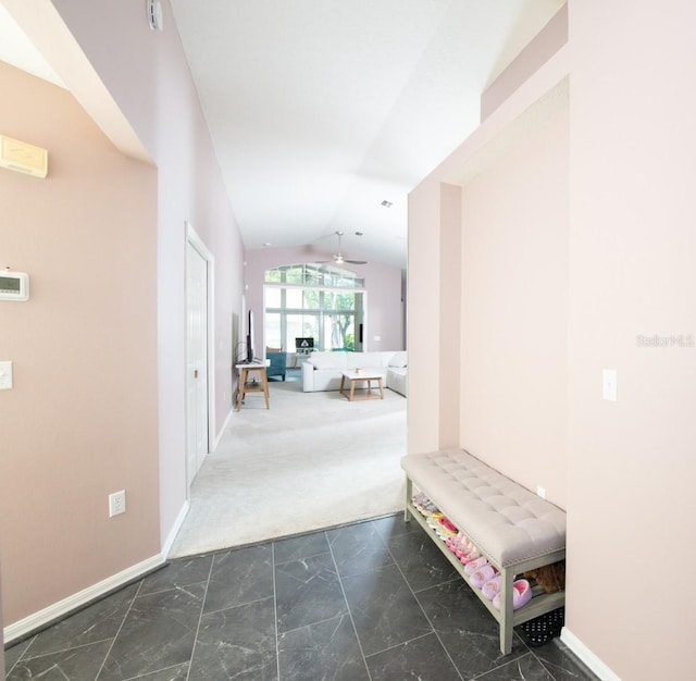 10321 Ravines Dr, New Port Richey, FL 34654 - hallway with lofted ceiling, baseboards, marble look tile flooring, and carpet flooring