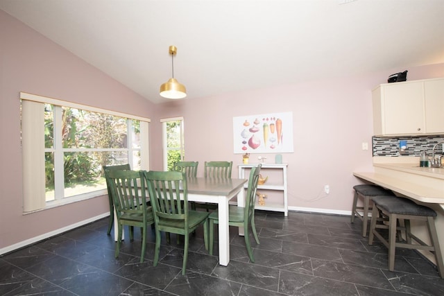 10321 Ravines Dr, New Port Richey, FL 34654 - dining room featuring baseboards, lofted ceiling, and dark marble finish flooring
