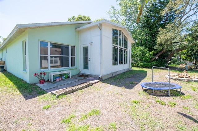 10321 Ravines Dr, New Port Richey, FL 34654 - rear view of house with a trampoline