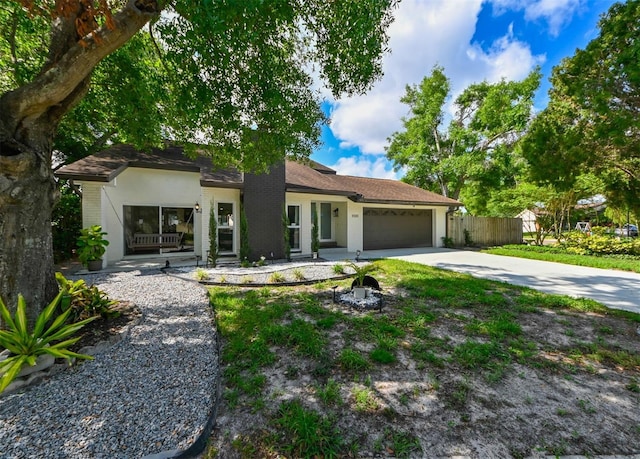 4520 Wescott Ln, Tampa, FL 33624 - ranch-style home featuring an attached garage, driveway, and fence