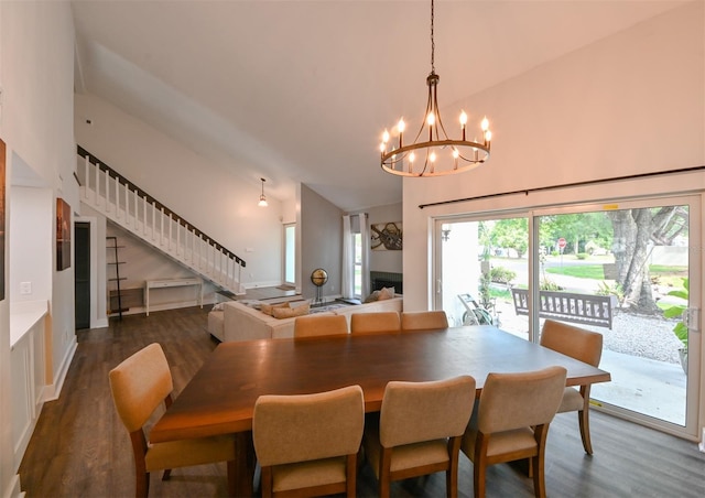 4520 Wescott Ln, Tampa, FL 33624 - dining area featuring high vaulted ceiling, a chandelier, stairs, and dark wood-style floors