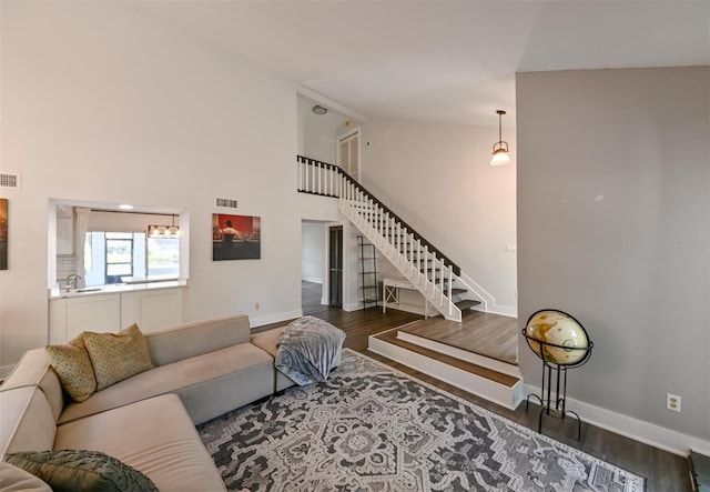 4520 Wescott Ln, Tampa, FL 33624 - living room with stairway, wood finished floors, and visible vents