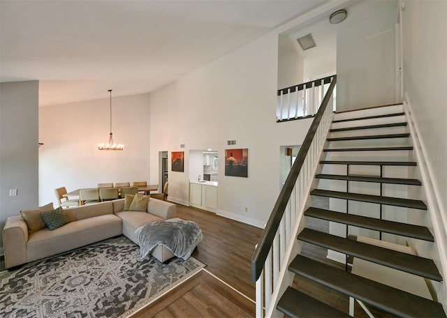 4520 Wescott Ln, Tampa, FL 33624 - living area featuring stairway, wood finished floors, visible vents, a chandelier, and high vaulted ceiling