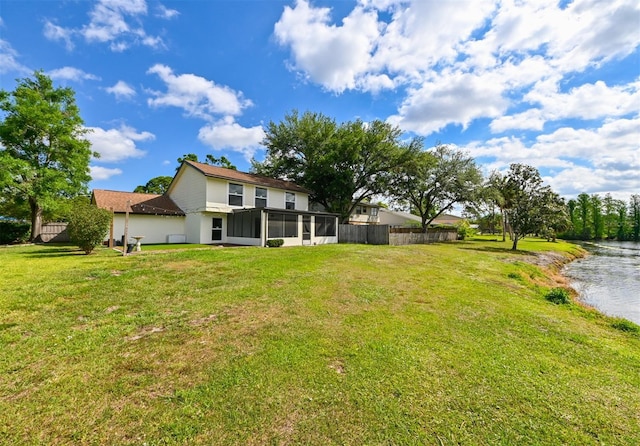 4520 Wescott Ln, Tampa, FL 33624 - view of yard with fence, a sunroom, and a water view
