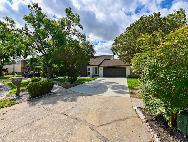 4520 Wescott Ln, Tampa, FL 33624 - view of front of house with stucco siding, driveway, and a garage