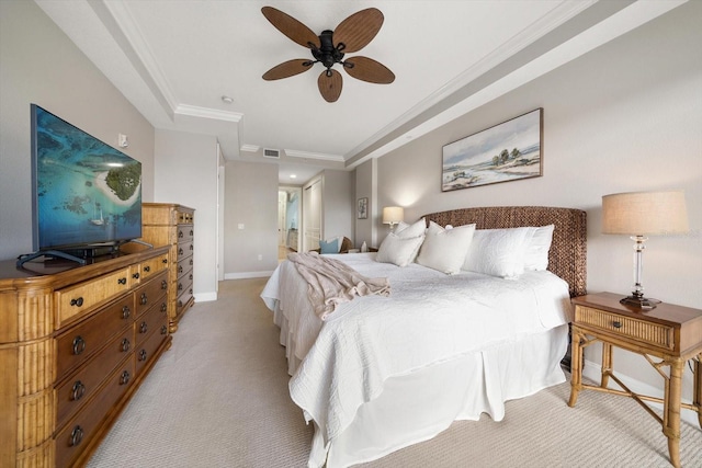 bedroom featuring a raised ceiling, visible vents, baseboards, light colored carpet, and ornamental molding