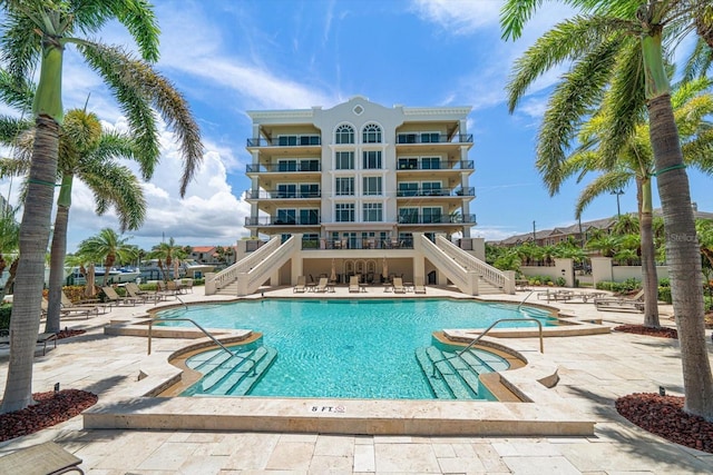202 Windward Psge Unit 304, Clearwater Beach, FL 33767 - community pool featuring stairway and a patio area