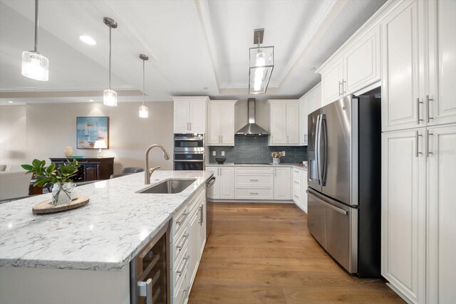 202 Windward Psge Unit 304, Clearwater Beach, FL 33767 - kitchen featuring stainless steel appliances, wall chimney range hood, a raised ceiling, white cabinets, and recessed lighting