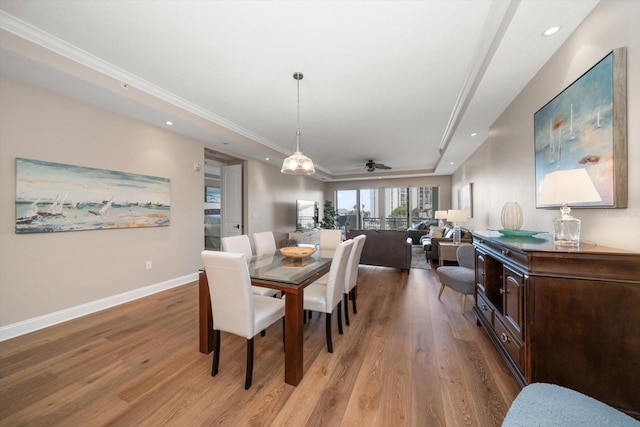 202 Windward Psge Unit 304, Clearwater Beach, FL 33767 - dining room featuring a tray ceiling, light wood-type flooring, ceiling fan, recessed lighting, and crown molding