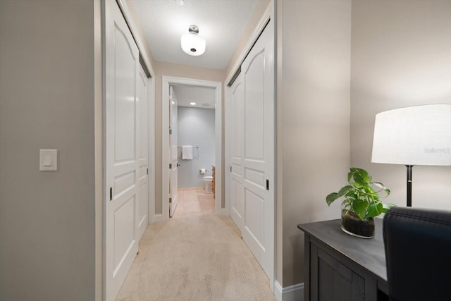 202 Windward Psge Unit 304, Clearwater Beach, FL 33767 - hall featuring light colored carpet and baseboards